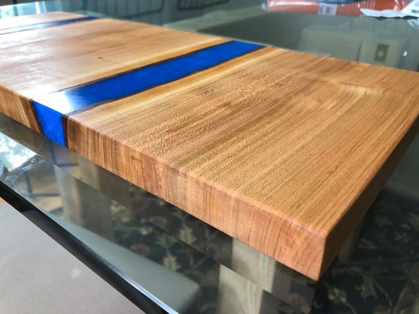 Live edge cutting board with blue resin river